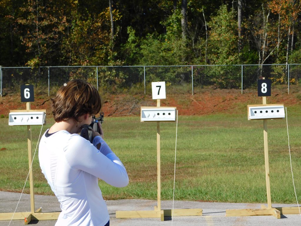 Competitors fire on knock-down targets before taking another run on the course.