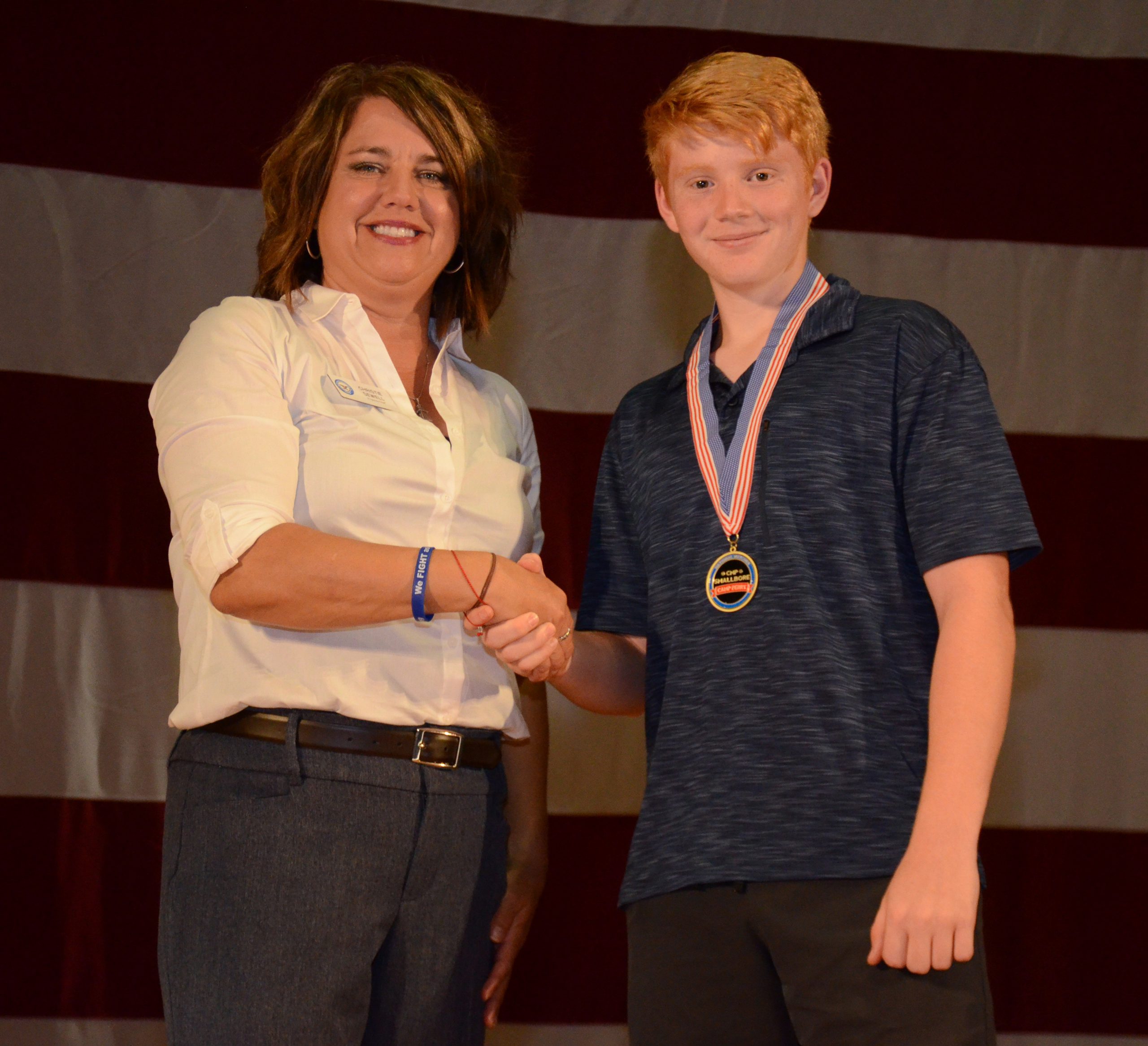 In 2019, Scott earned second in the CMP’s Junior 3P Smallbore National event at Camp Perry (shown with CMP programs chief, Christie Sewell).