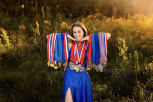 Breman Butler poses with her medals she’s earned from marksmanship events.