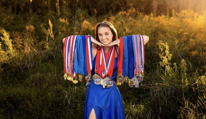 Breman Butler poses with her medals she’s earned from marksmanship events.